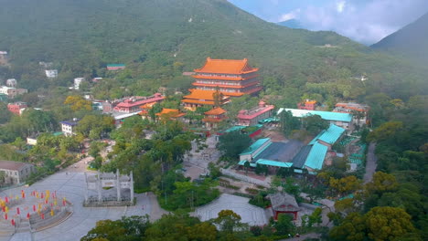 orange facade of po lin monastery the amidst the hills in ngong ping plateau in lantau island, hongkong