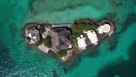 top down aerial view of small island in caribbean sea, buildings and coast