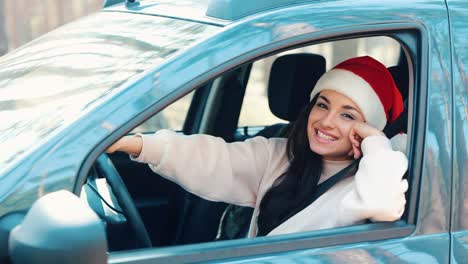 young woman sit in car during travelling break. slow motion of girl enjoying driving in car. new year or christmas period. holidays travelling. woman is alone in car but cheerful and happy.