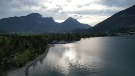 Aerial-view-of-Walensee-shoreline-with-boats-docked-on-Swiss-backdrop