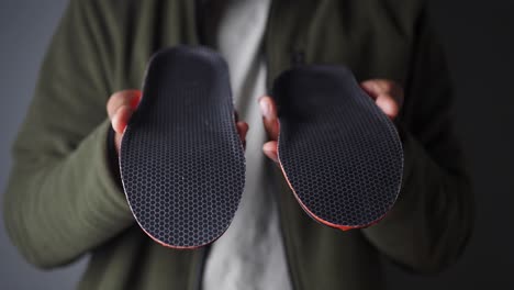 person holding insoles