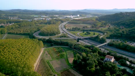 aerial image of the motorway road c32 barcelona france, flowing traffic of cars lush green vegetation