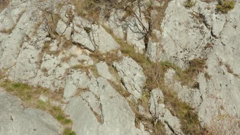 aerial shot rising up the side of a mountain near bela voda, serbia