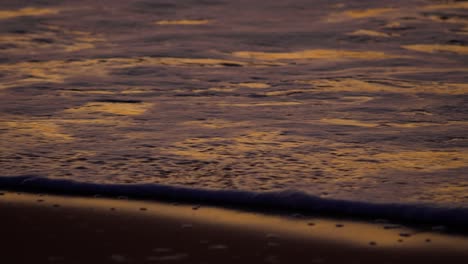 sunset sand reflections golden hour vivid colors at beach in slow motion medium shot