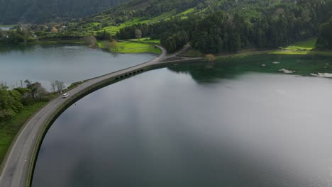 Car-crossing-Lagoa-das-Sete-Cidades-bridge-on-São-Miguel-island,-Azores,-Portugal