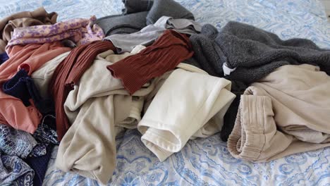 pile of clothes on a bed