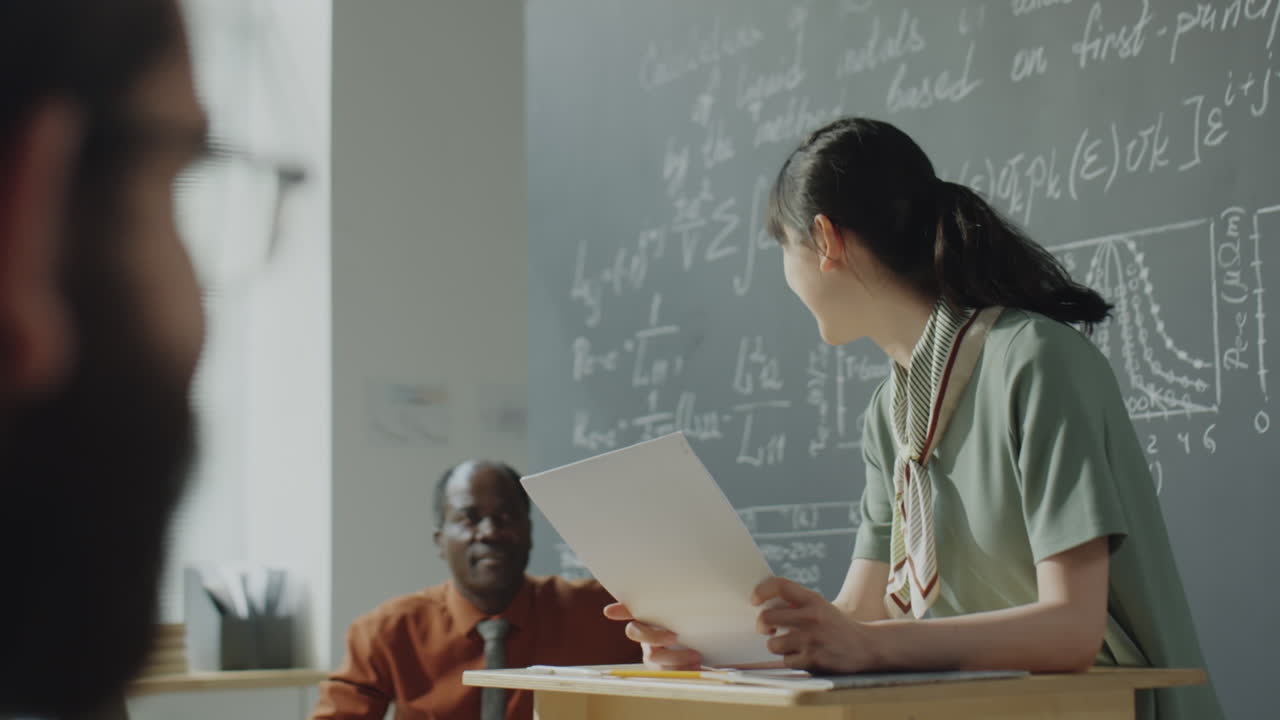 Asian Woman Giving a Science Presentation in a University Classroom
