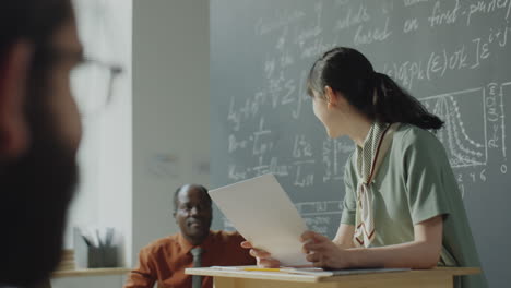 asian woman giving a science presentation in a university classroom