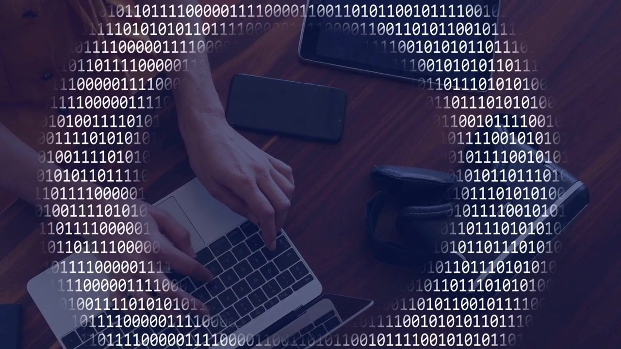 Woman's hands appearing and typing on laptop, working on tech task with binary rings layering desk