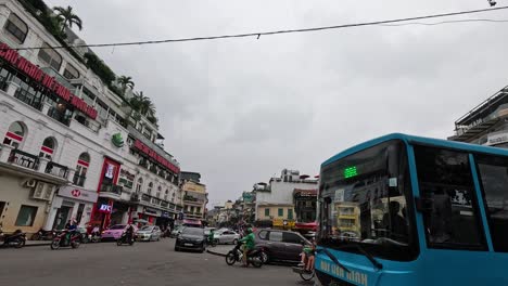 a bus moves through a bustling city street