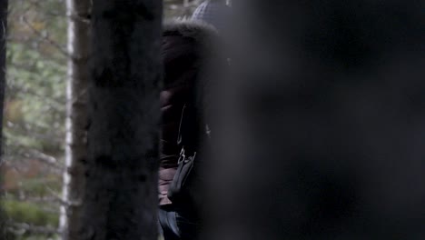 peekaboo tracking view of person in forest in iceland