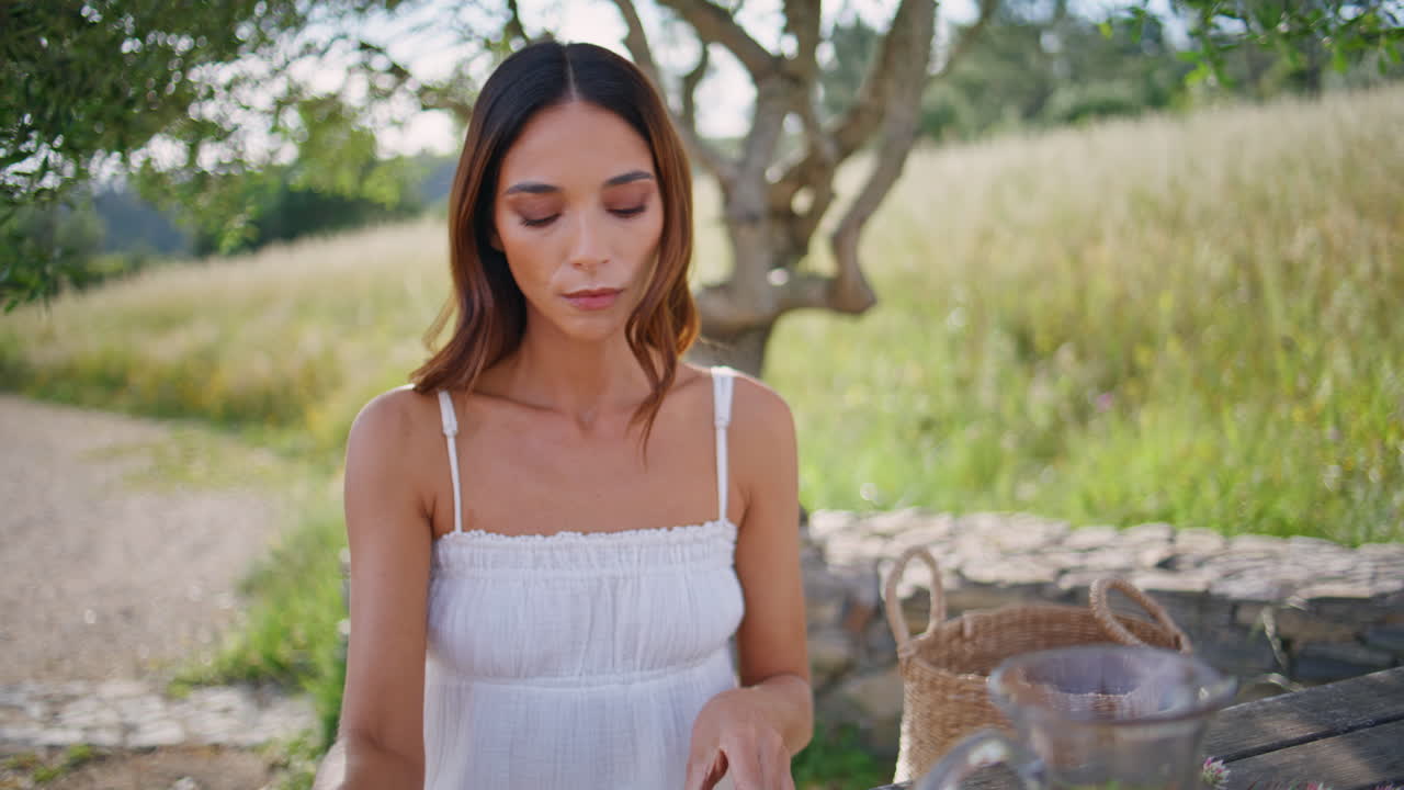 Rural woman looking smartphone sitting picnic closeup. Romantic lady resting