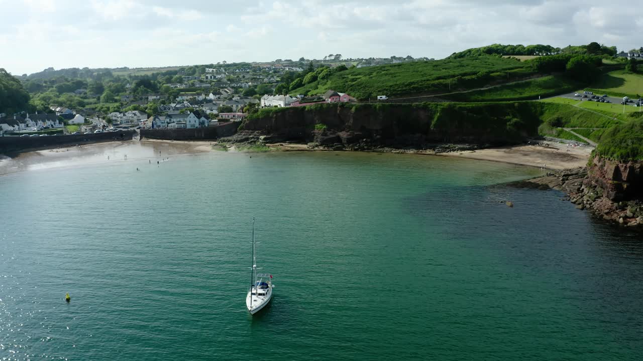 Drone shot of a sailboat moored in the Dunmore East Harbour.