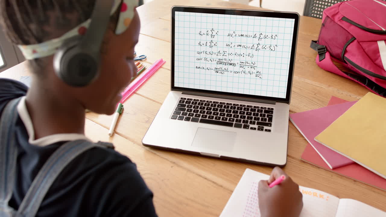 Composition of african american schoolgirl on laptop online learning with maths
