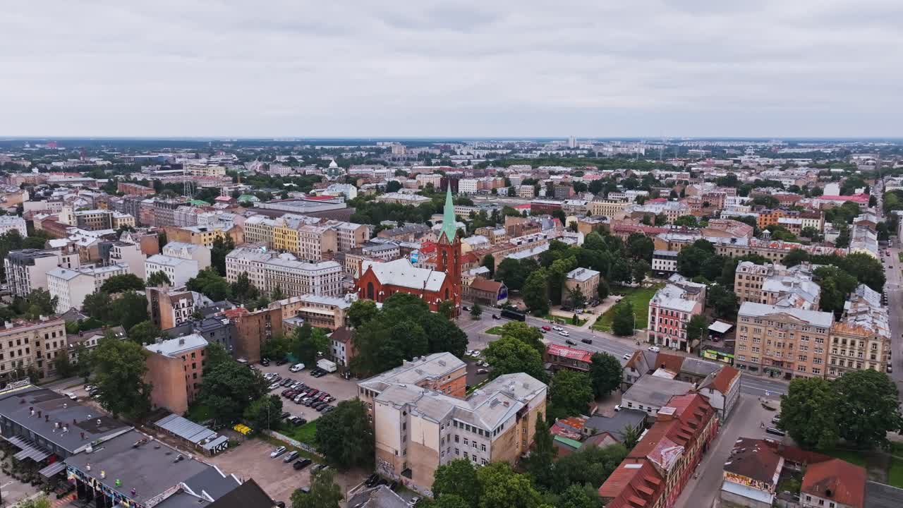 Drone lentää eteenpäin Riian keskustan yllä, Pyhän Gertrudin uusi kirkko näkyvissä