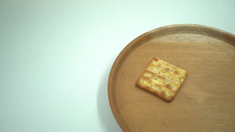 christmas cracker biscuit over the wooden plate, fork and spoon with white background.