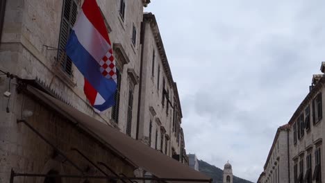 croatian flag waving in slow motion on the facade of an old building