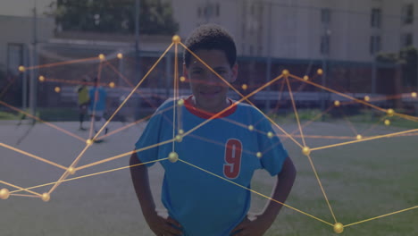 boy in blue jersey standing center soccer field, showing data network overlay streaming
