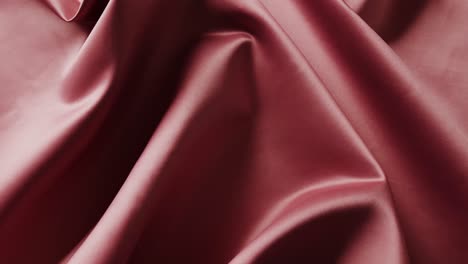 Close-up-of-red-shiny-silk-cloth-in-slow-motion