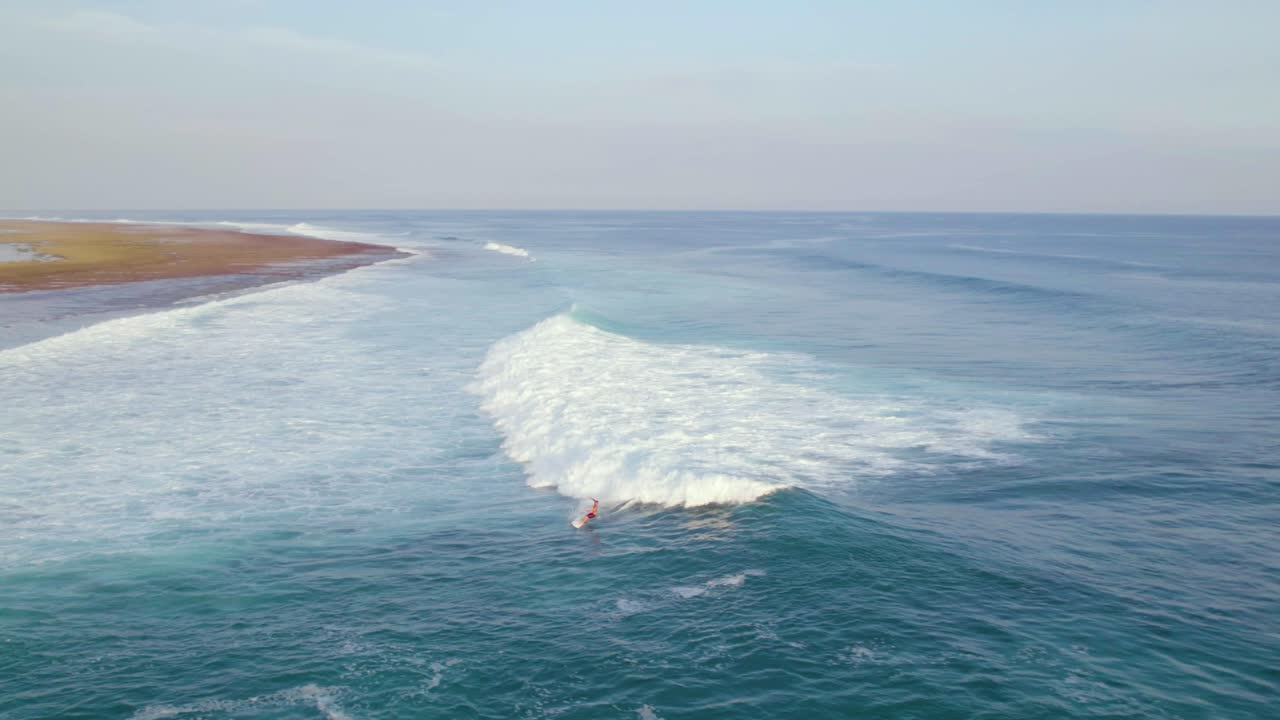 Surfer on Crashing Wave on Beautiful Uluwatu, Bali Coast - Aerial Drone View