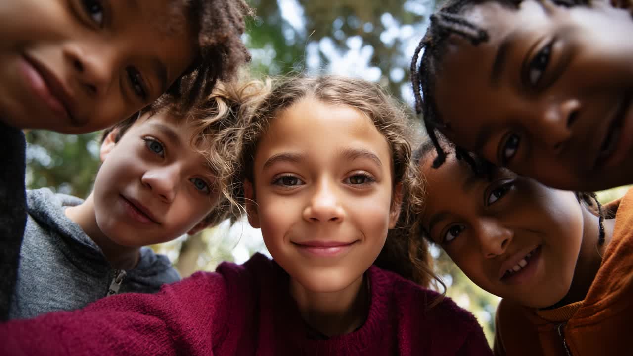 A joyful moment captured among five children, highlighting their playful expressions while they pose for a selfie in a lush outdoor environment, embodying the spirit of friendship and childhood innocence