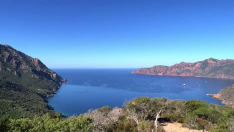 Panoramic-panning-view-of-Scandola-UNESCO-nature-reserve-in-summer-season,-Corsica-island-in-France