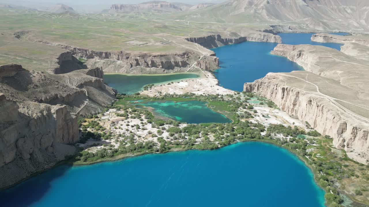 Band E Amir Drone Aerial, Afghanistan. Pristine turquoise lake oasis, lush trees in desert landscape