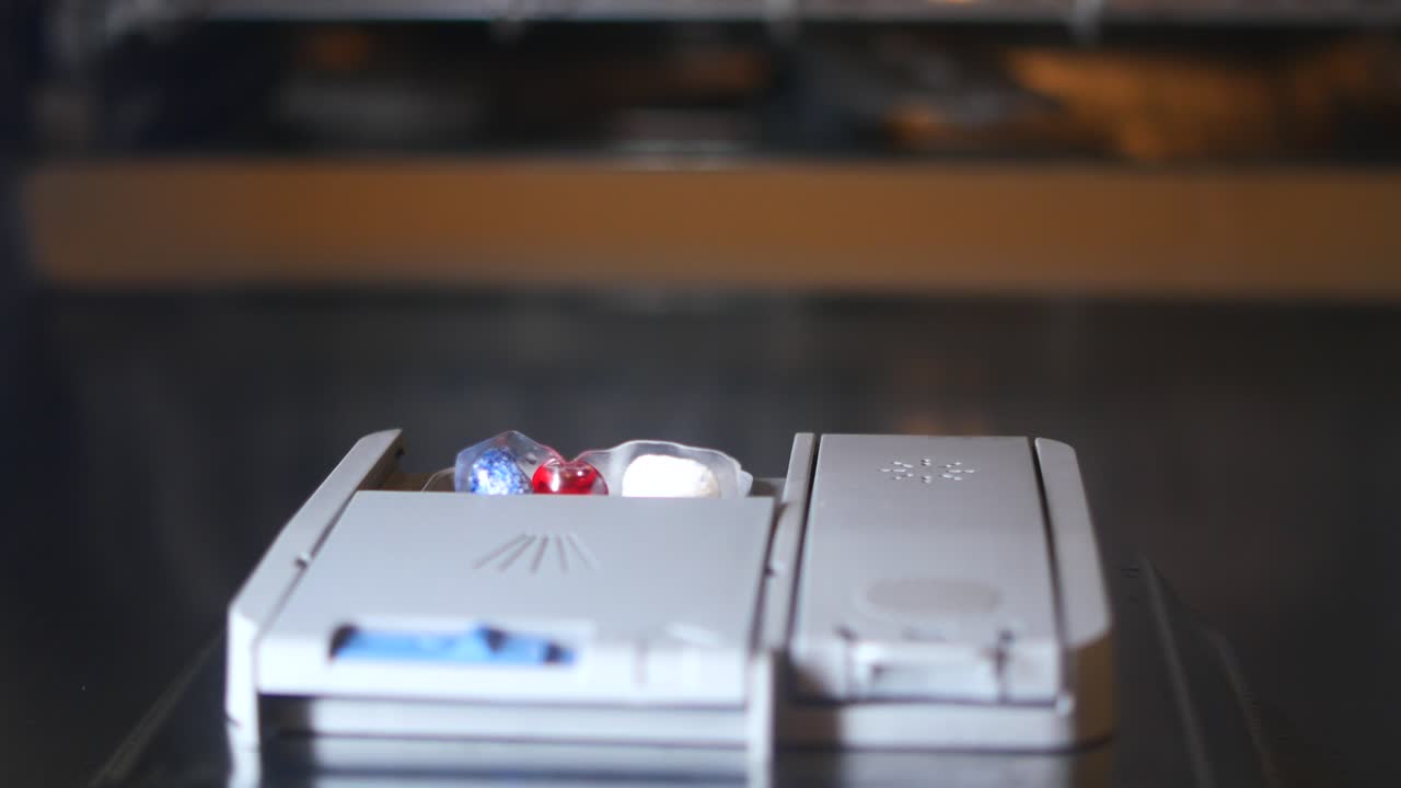 Hand loading detergent into a dishwasher