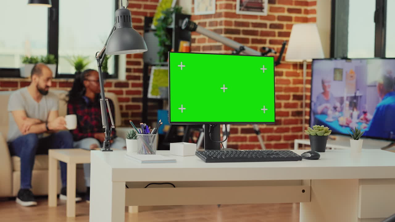Empty workspace table with greenscreen display on computer