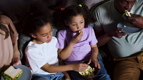 Kids-with-parents-watching-film-at-home