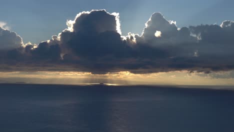 stunning time lapse with moving cumulus clouds above ocean during sunset