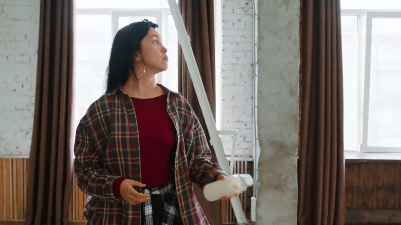 Young woman in plaid shirt in a dance studio