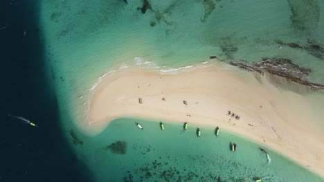 stunning aerial drone shot of an amazing, heavenly, paradisiacal sandbank beach with boats in zanzibar