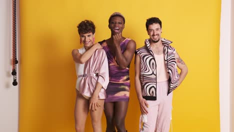 trans men posing while smiling at the camera in a photographic studio
