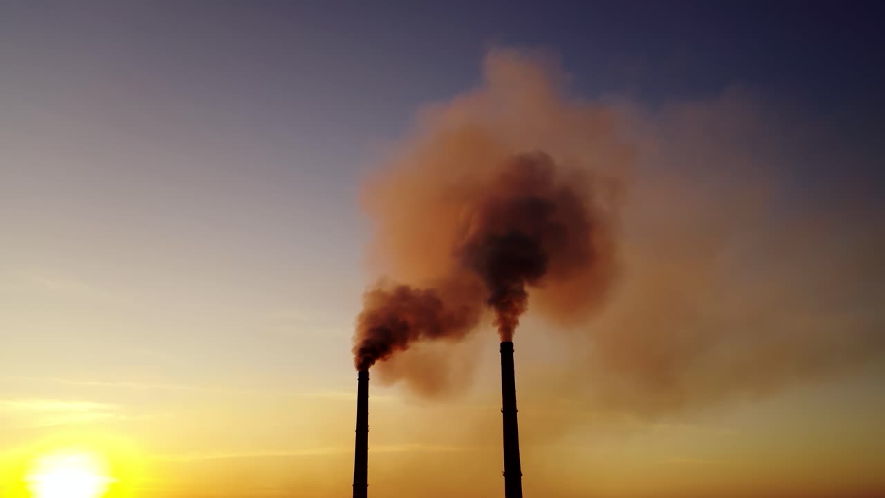 Plant pipe with smoke. Aerial view of high chimney pipes with grey smoke from power plant