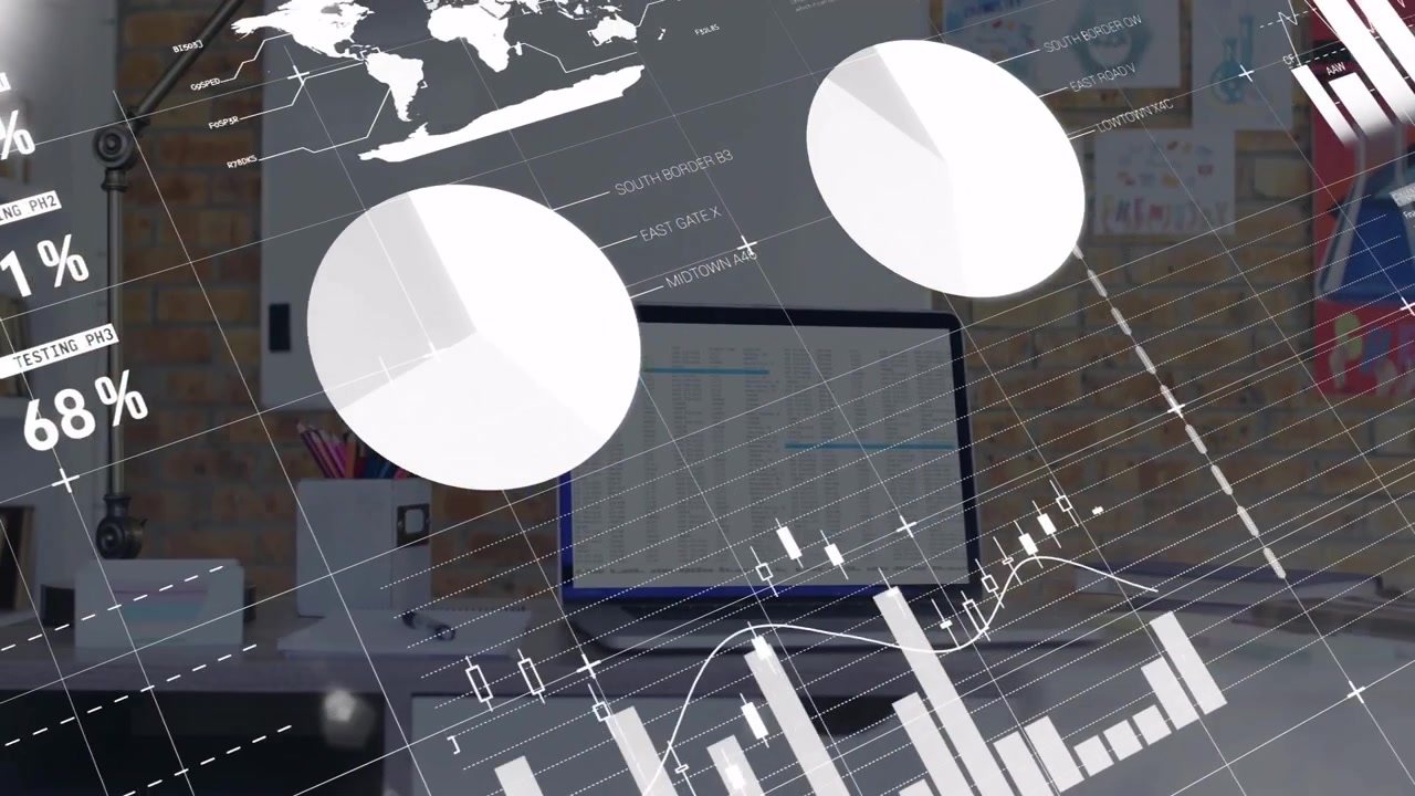 Financial charts and graphs over office desk with laptop