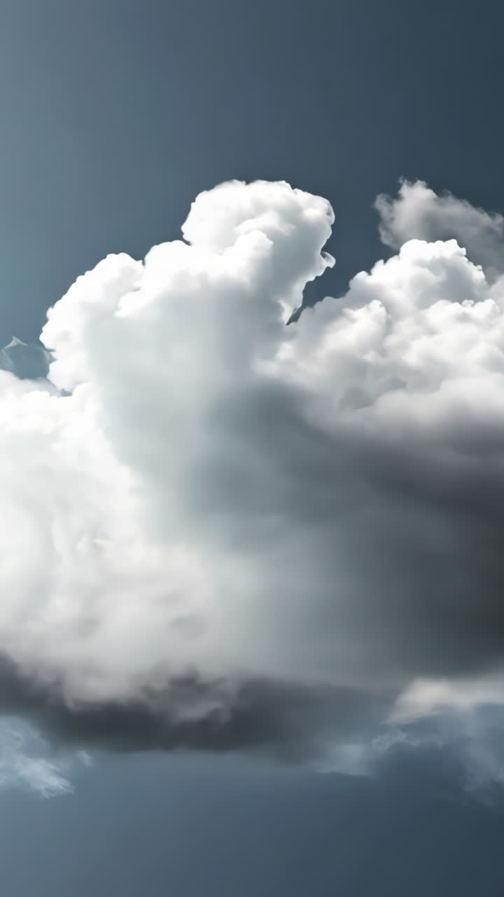 A large cloud of smoke is seen in the sky. The smoke is billowing and he is coming from a fire. The sky is dark and gloomy, with the clouds looming overhead. Scene is ominous and foreboding