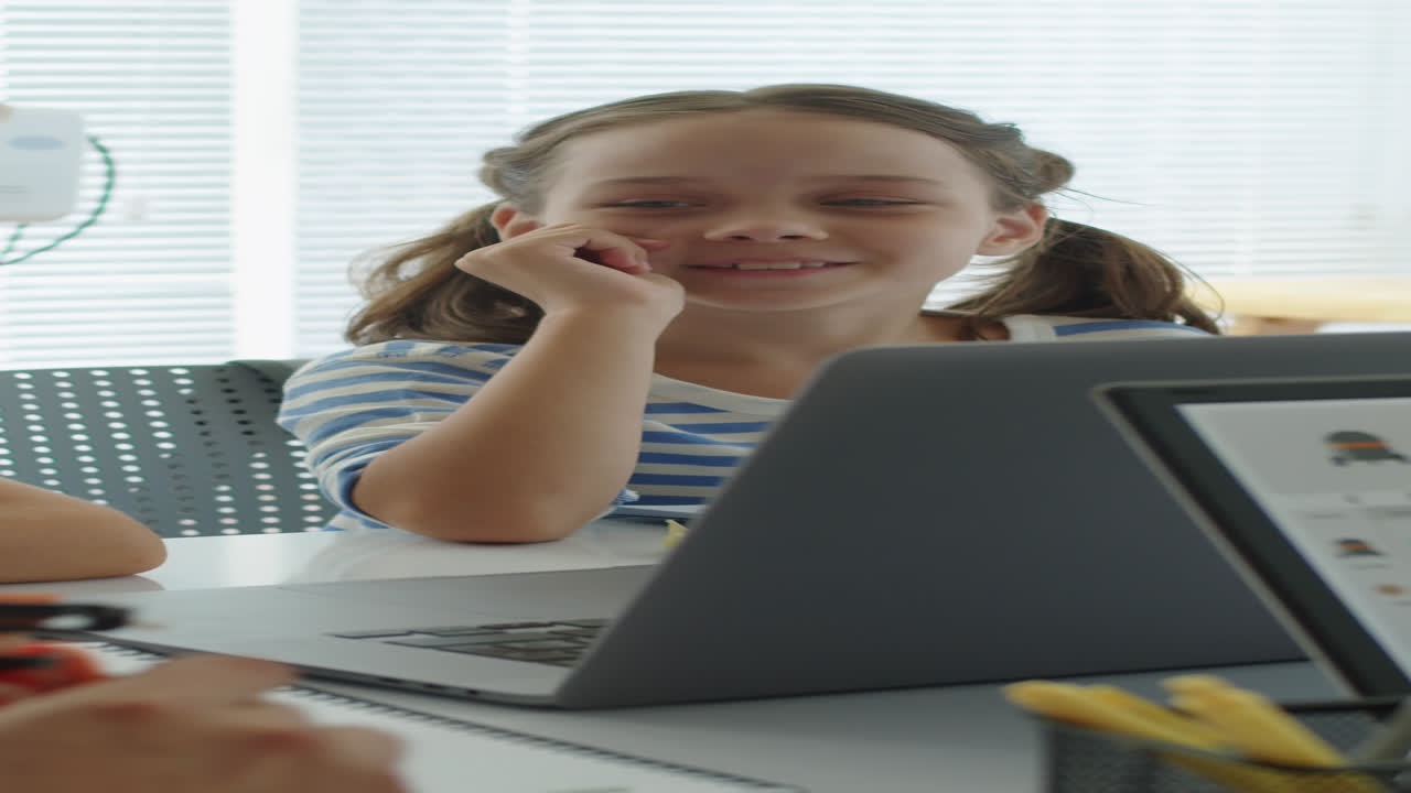 Schoolgirl Listening to Teacher Talking about Robots Engineering