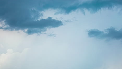 dark cloud expansion over white moving clouds