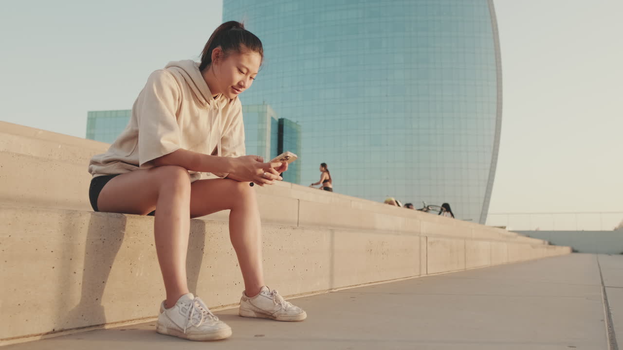 Woman sitting on steps in the city
