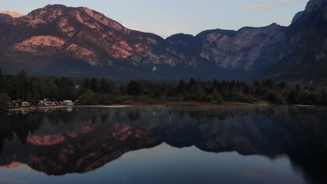 nice reflection of the mountains in the water of lake bohinj in slovenia