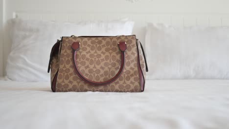 coach handbag on a bed