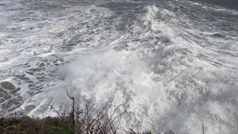 large storm surge wave crashes over concrete platform, tramore ireland