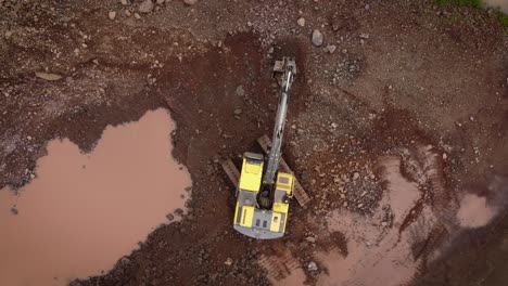 excavator removing rocks in open stone quarry in brazil