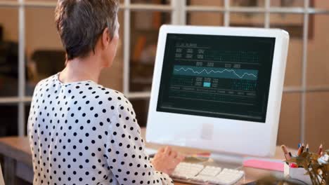 Male-executive-using-digital-tablet-at-desk