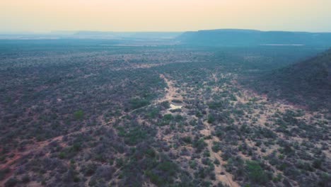 Aerial-Drone-shot-of-a-dried-up-pond-in-a-semi-arid-forest-of-Madhya-Pradesh-India