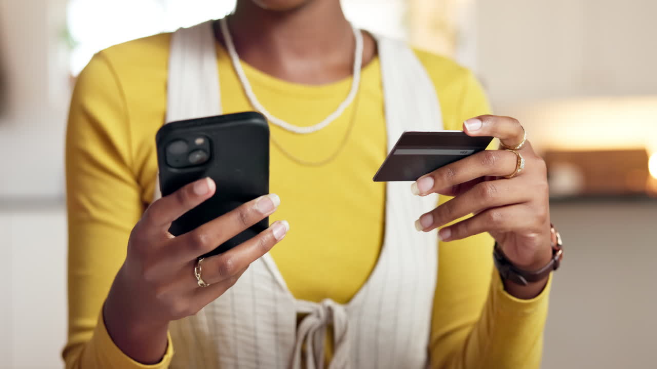 Frau kauft mit Kreditkarte und Handy online ein