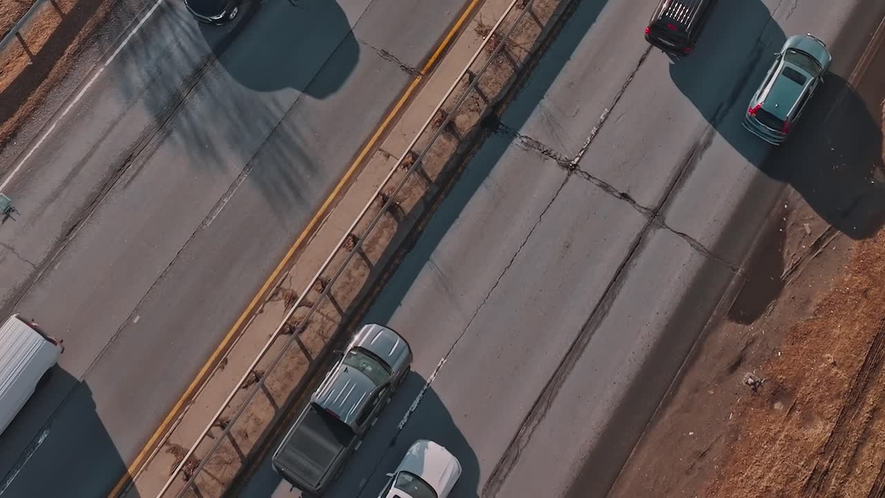 Top Down View of Cars on an Expressway with Dirt Shoulder
