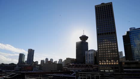 Vancouver-downtown-establishing-shot-with-seagulls-flying,-sunny-and-cold-day