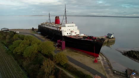 decaying rusty tss duke of lancaster ship moored near mostyn docks - aerial orbit